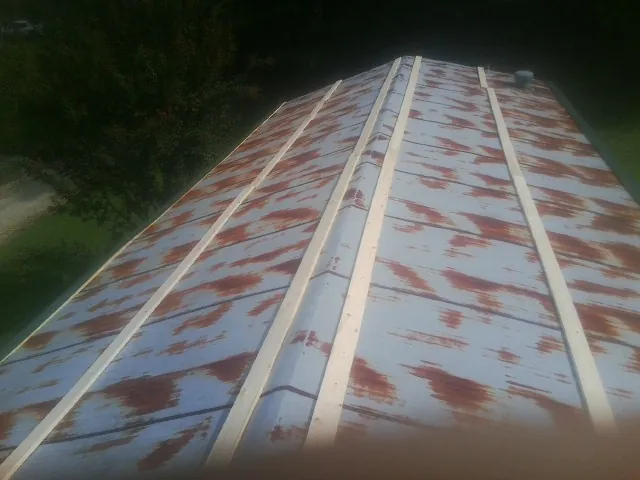 Rusted metal roof panels with new wood purlins before replacement — Storm Damage Roof Repair in Sonora by Roofing Brothers