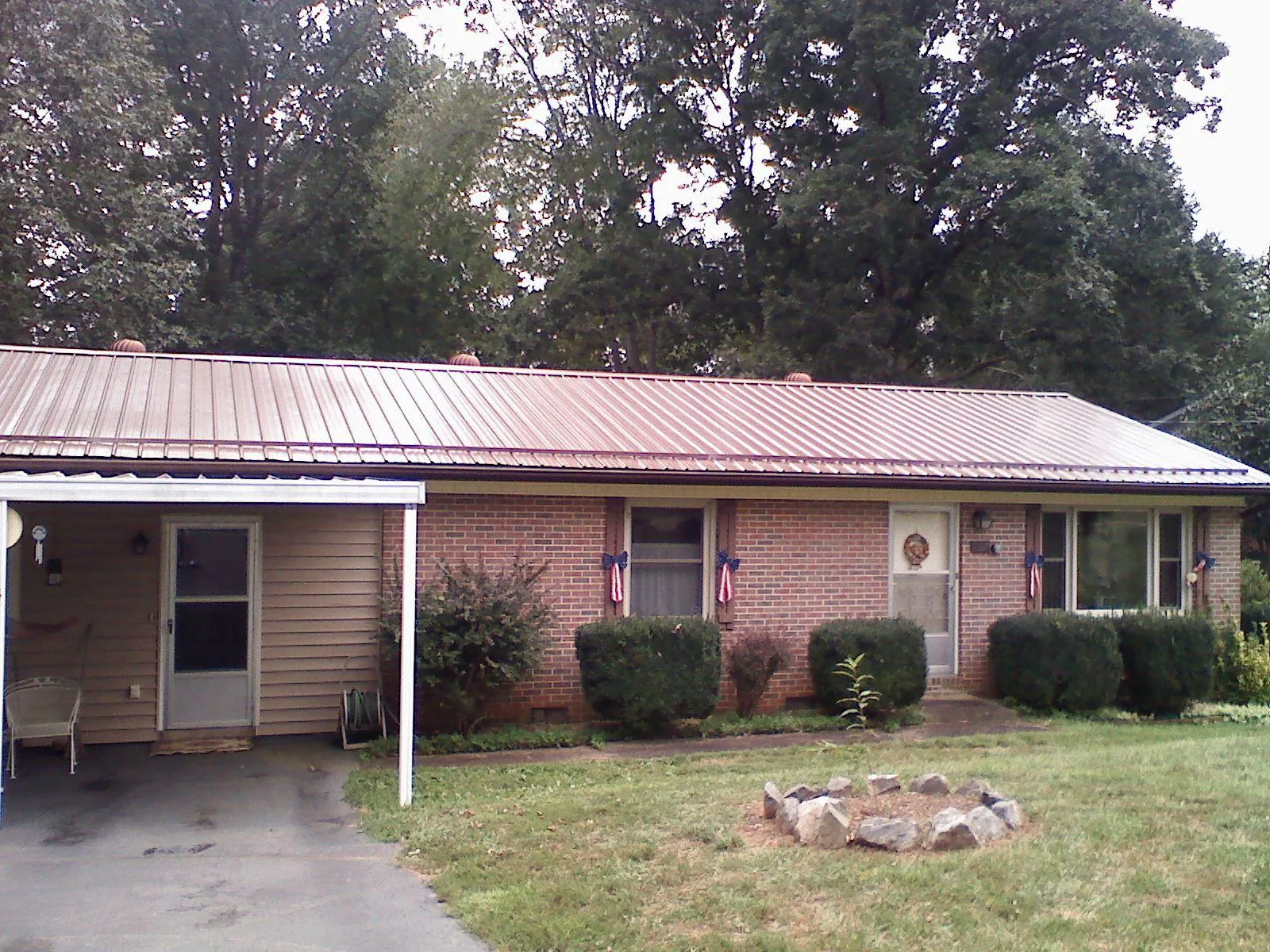 Bronze metal roof and carport on a brick ranch home — Roof Repair work by our crew in Sonora